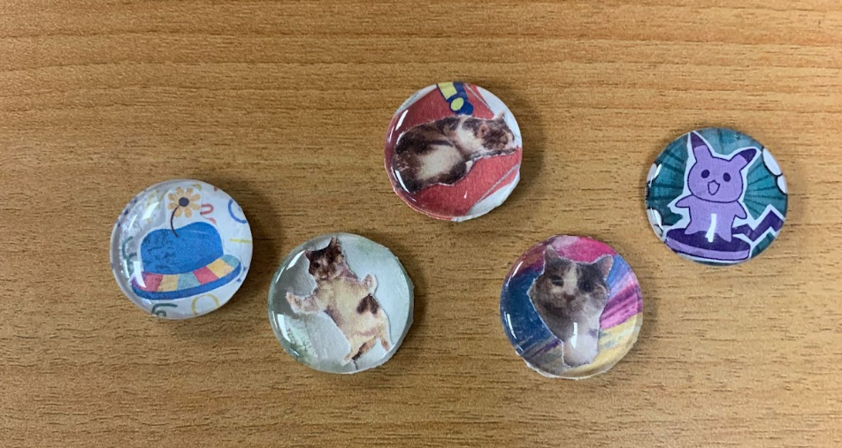 Final products of Photo Magnets. Images of cats, hats on a desk surface